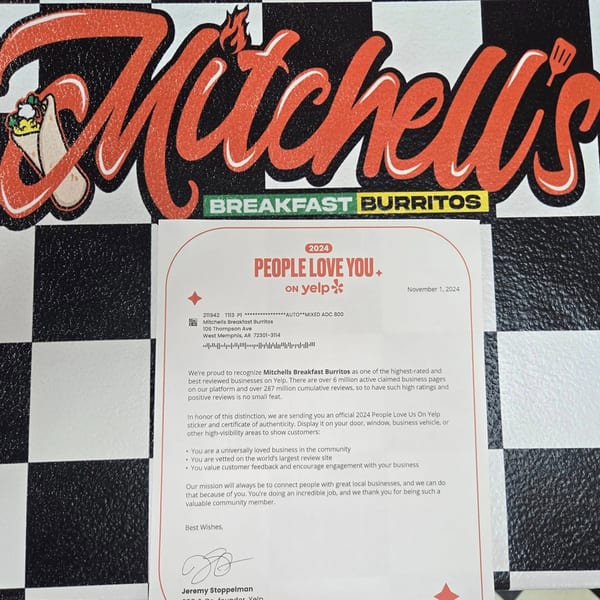 Yelp's "People Love You" award letter for Mitchell's Breakfast Burritos on a checkered background.